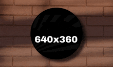 a brick wall with a black circle that says 640x360 on it