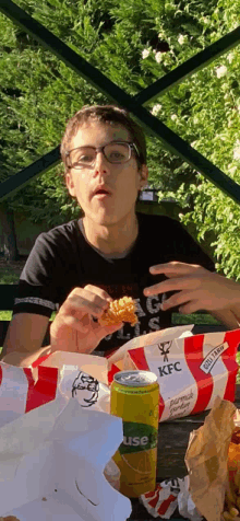 a boy is eating a kfc chicken nugget