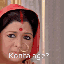 a woman with a nose ring and a red dot on her forehead asks " konta age "