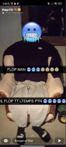 a man is sitting in a chair with a blue smiley face on his face and a caption that says flop man