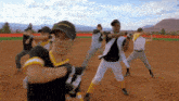 a group of baseball players are practicing on a field and one of them is wearing a hat that says ' goodyear '