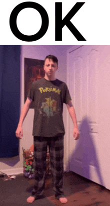 a man wearing a pokemon shirt stands in front of a door