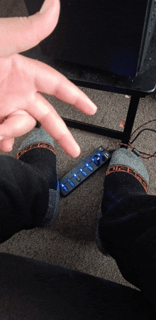 a person wearing a pair of dickies socks standing next to a power strip