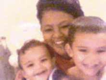 a woman is holding two children in her arms and smiling .