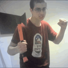 a man in a red shirt holds a large axe with the year 1946 on it