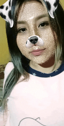 a woman wearing a dalmatian dog mask on her face