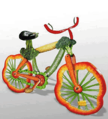 a bicycle made out of vegetables including broccoli carrots and peas