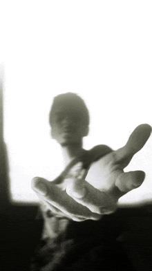 a blurry photo of a hand reaching out