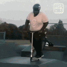 a man wearing a helmet is riding a scooter at a skate park with the year 1968 on the bottom