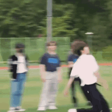 a blurry picture of a group of people playing a game on a field .