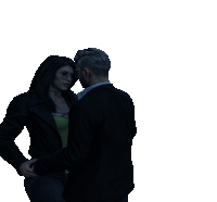 a man and a woman are standing next to each other in the dark