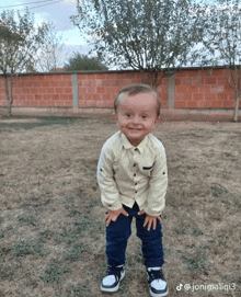 a little boy standing in a field with the hashtag jonimaliqi3