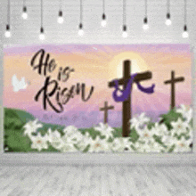 a wall with a banner that says `` he is risen '' with crosses and lilies .