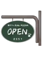 a green sign that says kitty mocha open on it