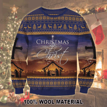 a blue sweater with the words christmas begins with christ