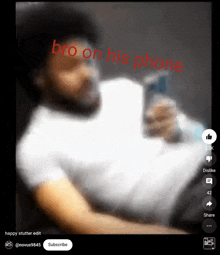 a blurry picture of a man holding a cell phone with the words bro on his phone above him