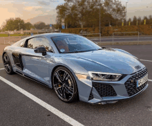 an audi r8 is parked in a parking lot with a license plate that says kfk r888