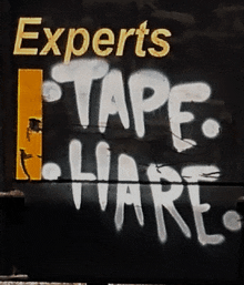 experts tape liars is spray painted on a black surface