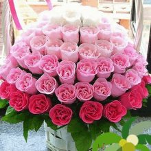 a bunch of pink roses in a basket