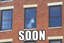 a brick building with a horse in the window and the words soon