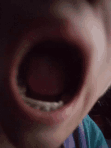 a close up of a person 's mouth with their tongue hanging out