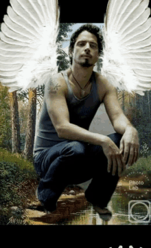 a photo of a man with angel wings is taken by the photo lab