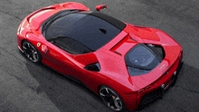 a red ferrari sports car is parked on the road