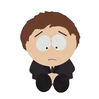 a south park character is sitting on the floor with his head down