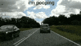 a car driving down a road with the words " i 'm pooping " on the top