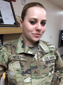 a woman in a us army uniform has the name neisz on her uniform