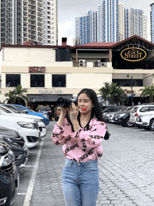 a woman taking a picture in front of the cable car