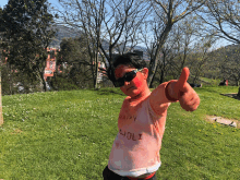 a person with red paint on their face and a shirt that says happy holi