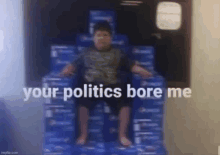 a young boy is sitting on top of a pile of pepsi boxes .