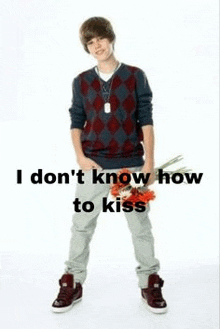 justin bieber is holding a bouquet of flowers and says `` i don 't know how to kiss '' .