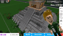 a boy in a green shirt is standing in front of a pyramid in a roblox game