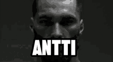 a black and white photo of a man with the word anti in white letters