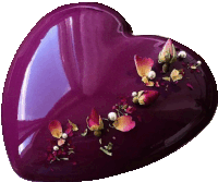 a purple heart shaped object with flowers and pearls on top