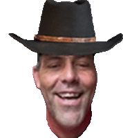 a man wearing a cowboy hat is smiling