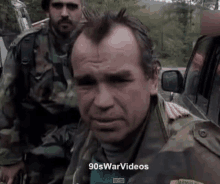 a man in a military uniform is shown in a 90s war video