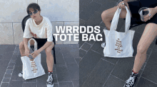 a woman is sitting on a chair holding a white tote bag that says wrrdds tote bag