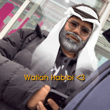 a man with a beard and glasses is wearing a scarf around his head and the name wallah habibi is on the bottom