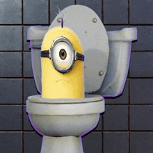 a toilet with a minion on it with a sad face