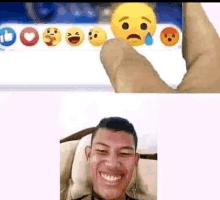 a man is smiling in front of a screen with emojis on it and another man is holding a smiley face .