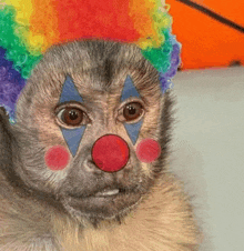 a close up of a monkey with a clown face painted on its face