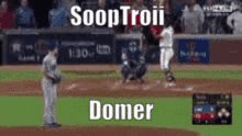 a baseball game is being played on a field with a sign that says ' soaptroii domer ' on it