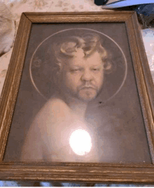 a framed picture of a man with a beard and a circle around his head