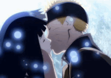 a man and a woman are kissing each other in the snow .