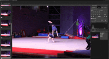 a computer screen shows a gymnast doing a handstand