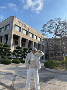 a man standing in front of a building with chinese writing