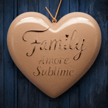 a heart shaped ornament with the words family amore sublime written on it